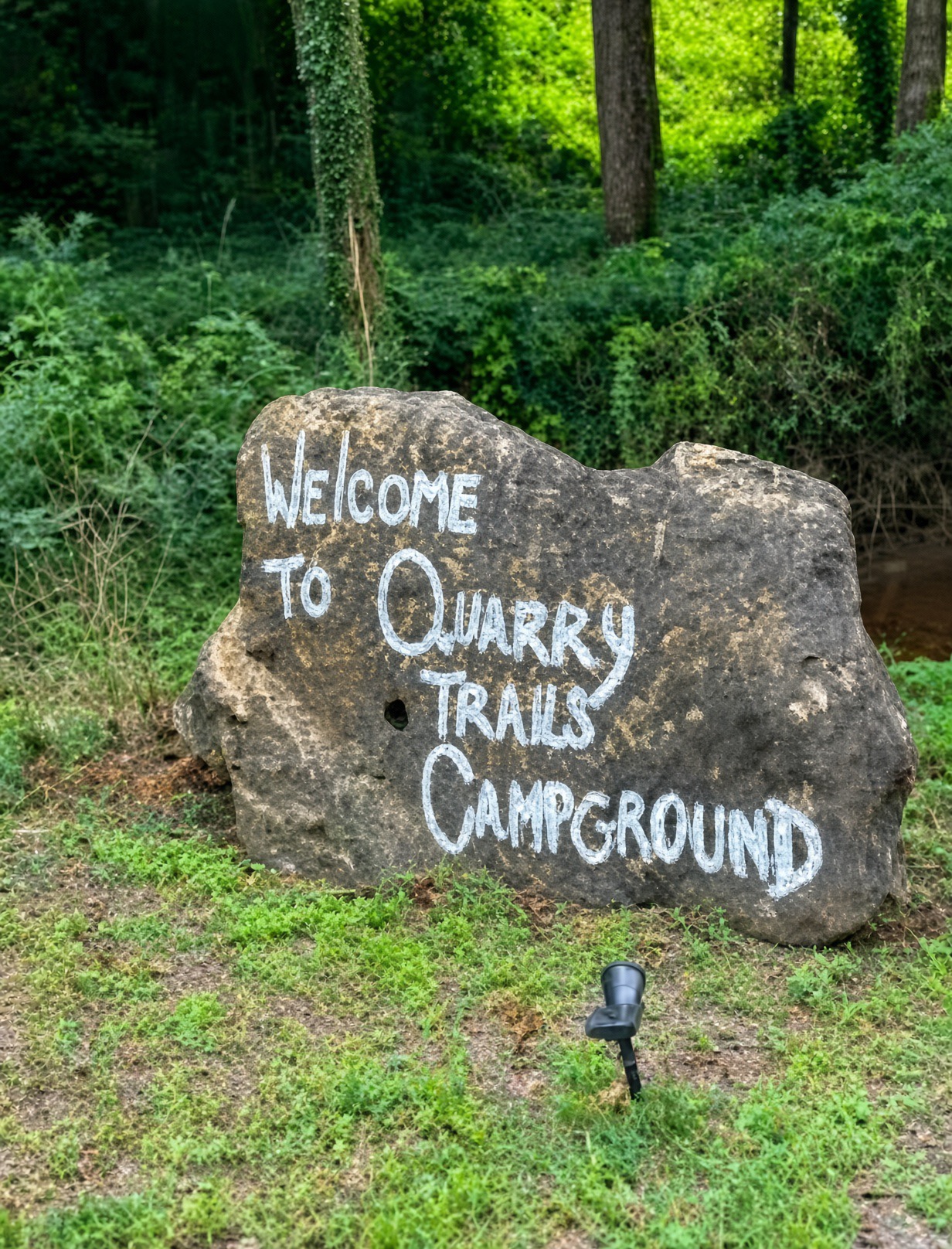 Welcome to Quarry Trails Campground painted on a quarry stone